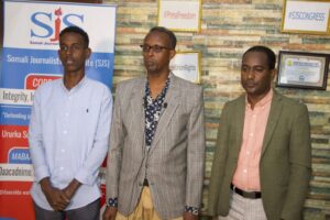 SJS legal representative, Avv. Abdirahman Hassan Omar (centre), SJS Secretary-General, Abdalle Mumin (right) and Sharma’arke Abdinur Wehliye speak at the a press conference in Mogadishu, Saturday 19 June, 2022. | PHOTO/SJS. Mohamed Jibril